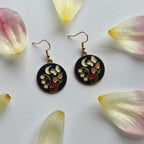 Navy blue circle with flowers and butterfly gold earrings