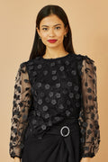 Top Yumi noir transparent à manches et fleurs appliquées