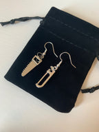 Silver hacksaw or saw earrings.